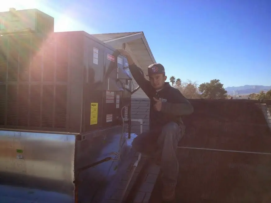 HVAC technician performing Air Duct Repair on a rooftop unit in Village of Oak Creek (Big Park)
